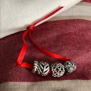 3 Pandora Elegant Silver Charms and a Pandora heart spacer.